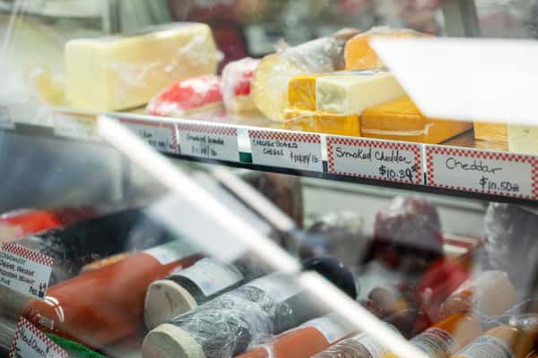 deli case with assorted cheeses and meats on display inside G&W Sandwiches