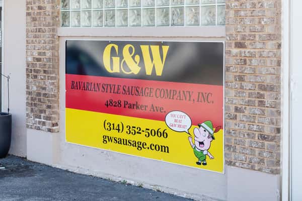 G&W Sausage Company sign with branding and contact details on brick exterior wall