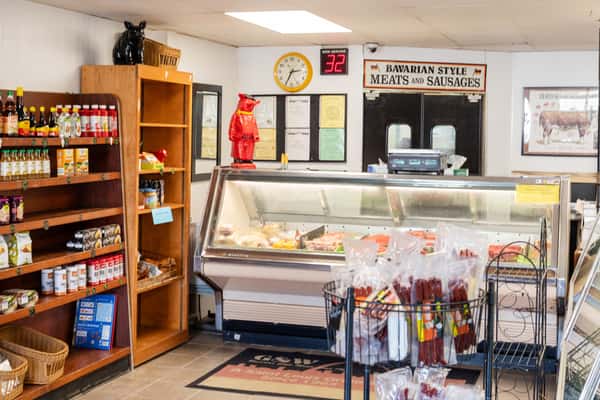 deli display case with assorted cheeses and meats inside G&W Sandwiches shop
