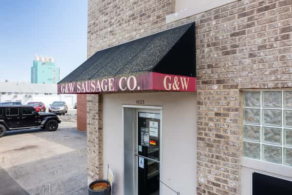 G&W Sausage Co storefront entrance with brick exterior and branded awning