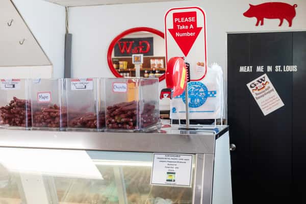 counter area inside G&W Sandwiches with deli case, signage, and ordering station