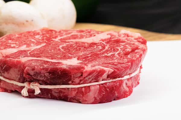 raw chuckeye steak with rich marbling displayed on butcher paper ready for cooking