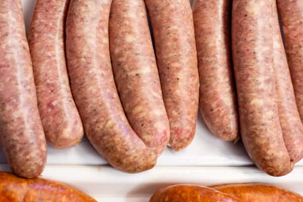 fresh sausages lined up in deli display case inside G&W Sandwiches