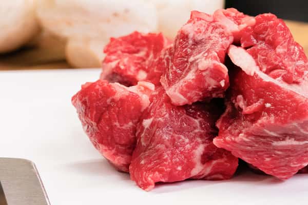 raw beef stew meat chunks with visible marbling ready for slow cooking