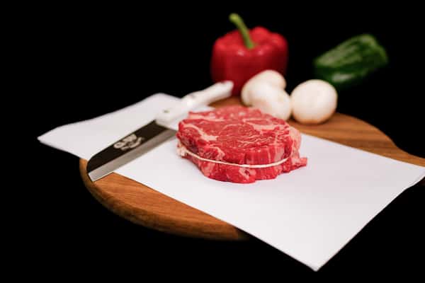 raw chuckeye steak with rich marbling displayed on butcher paper ready for cooking