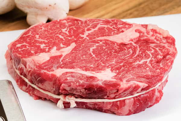 raw chuckeye steak with rich marbling displayed on butcher paper ready for cooking