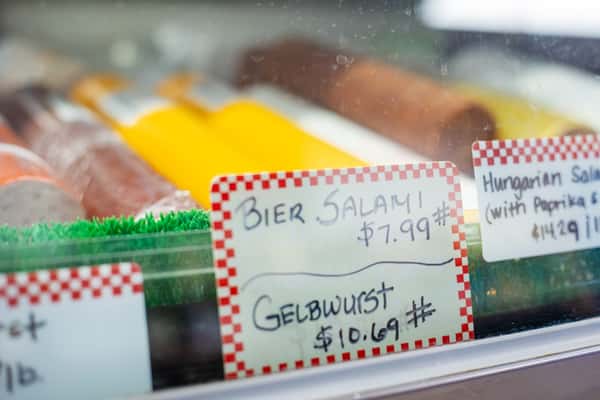 deli case labels showing bier salami and gebwurst prices inside G&W Sandwiches