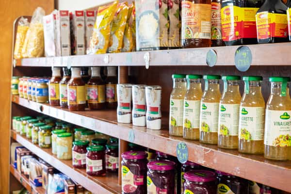 grocery shelves inside G&W Sandwiches with sauces, juices, and pantry items