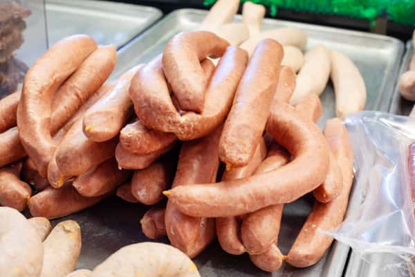 pile of fresh sausages in metal tray at G&W Sandwiches butcher counter