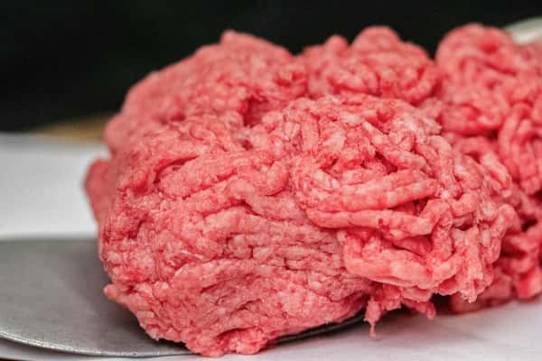 close-up of fresh ground beef portion with coarse texture ready for cooking