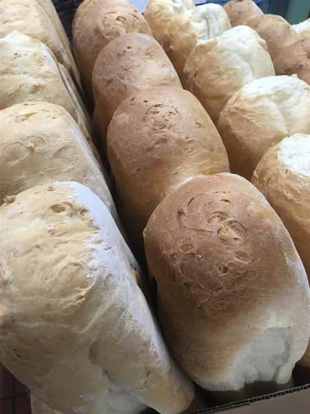 Fresh baked rolls coming out of the oven.