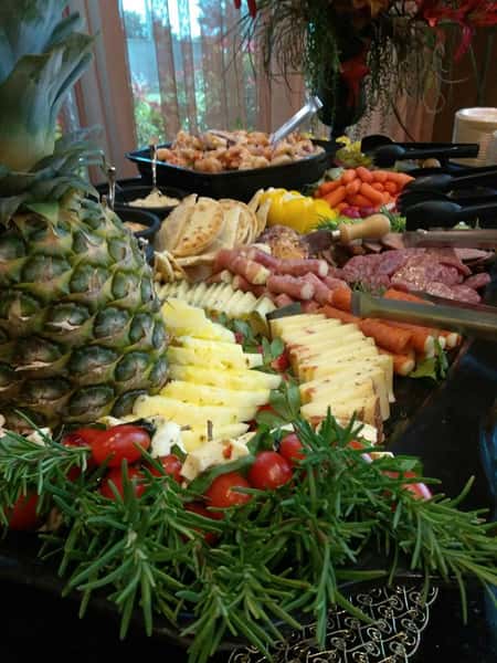 table of cold appetizers including assorted fruit, meats, cheese, and veggies