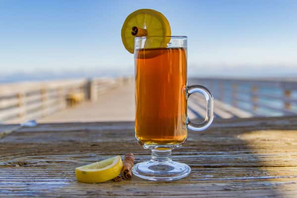 Cocktail with lemon and cinnamon stick