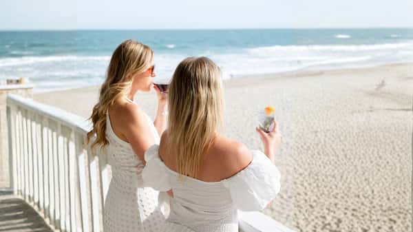 Women drinking cocktails with waterfront views at Oceanic