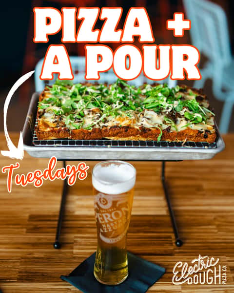 Photo of an Electric Dough PIzza Co. Pizza on a stand with a tall glass of beer in front of it. Text that reads PIZZA + A POUR TUESDAYS