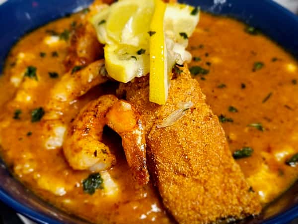 Shrimp and Grits with a red garlic butter gravy sauce