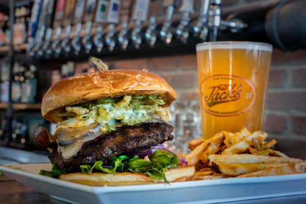 hand crafted burger with fries and beer