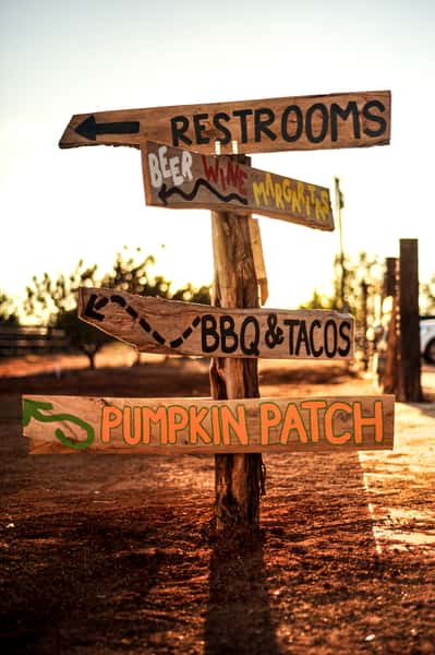  Wood street signs leading to BBQ & Tacos