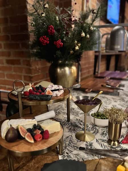 A table display of cheeses and appetizers