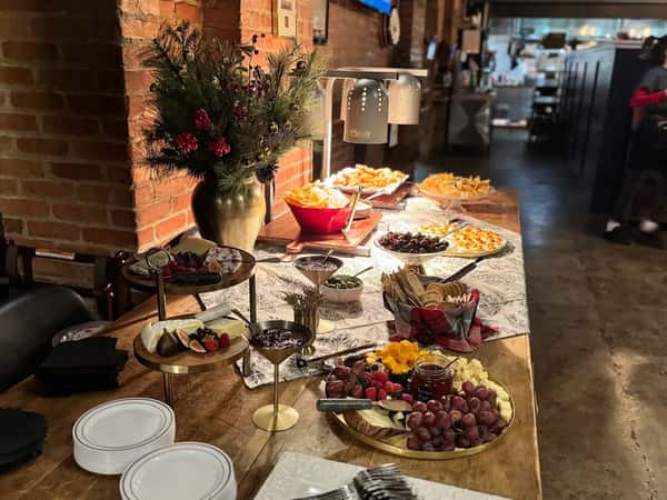 A table display of cheeses and appetizers