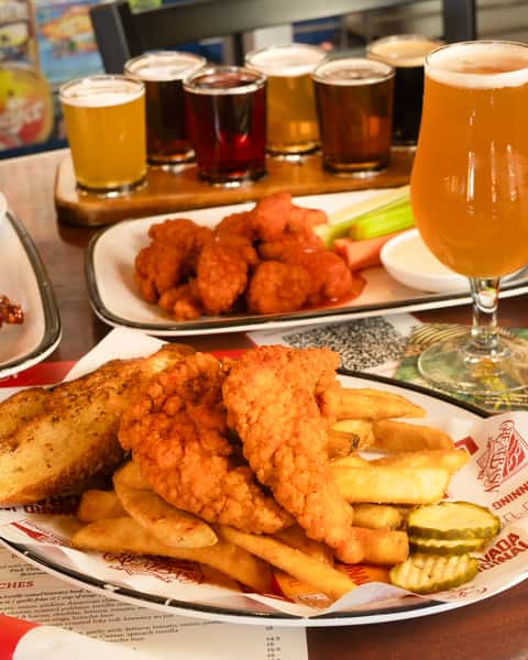 Nashville chicken tenders next to buffalo boneless wings.