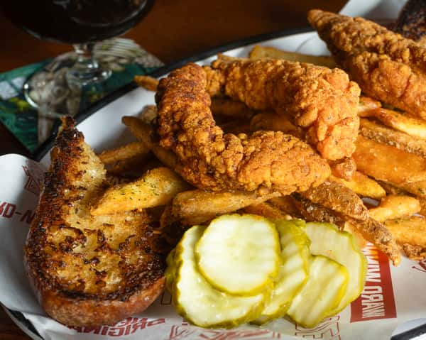 Nashville chicken tenders with fries and pickles.