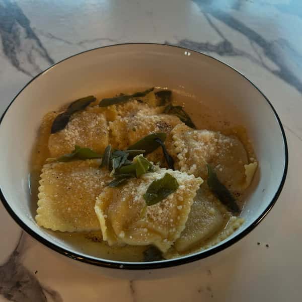New for Fall, our scrumptious Butternut Squash Ravioli served with brown butter, Parmesan, pine nut gremolata and crispy sage. Already a staff favorite, soon to be yours too! #new menu #fallmenu