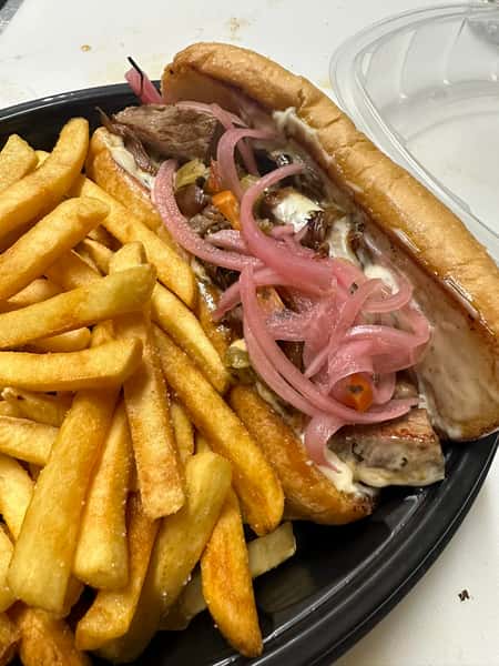 Toasted hoagie roll filled with sliced beef, melted cheese, pickled red onions, and peppers, served with seasoned fries.