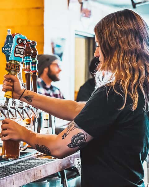 Bartender Pouring Beer for Guest from tap