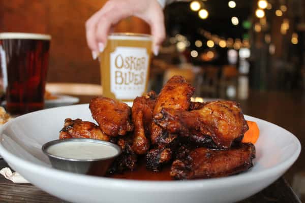 plate of wings with pint of beer