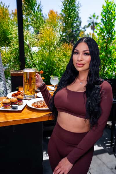 Server posing in front of food