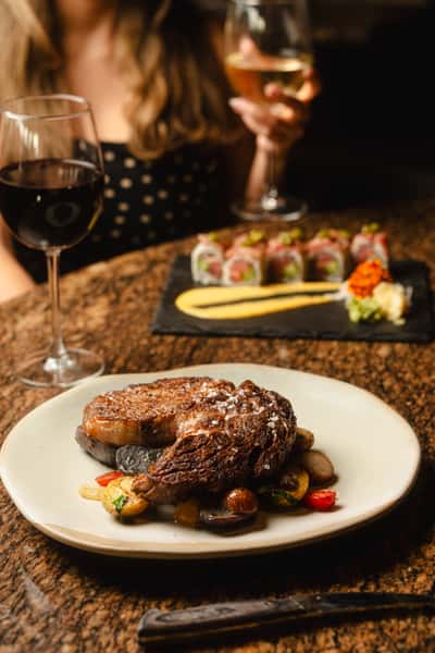 Ribeye and Sushi Roll with a red wine