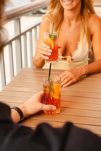 Guests holding Aperol Spritz Drink