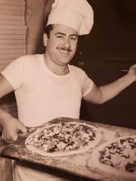 owner with pizza