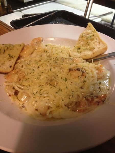 pasta in a bowl with cheese and bread