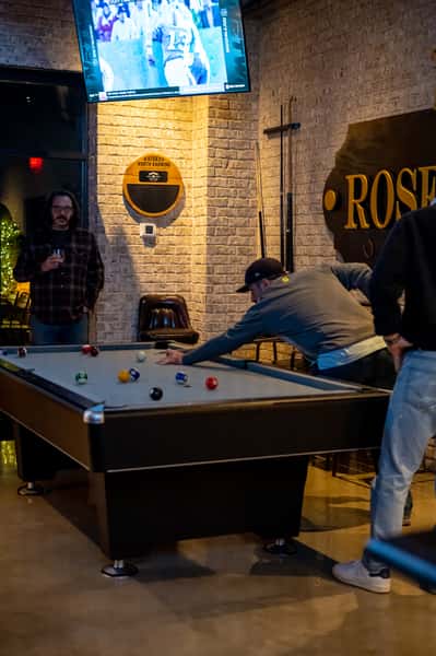 Patrons playing pool