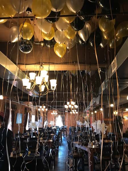 the ceiling with multiple balloons floating at the top