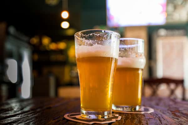 2 beers sitting on the bar