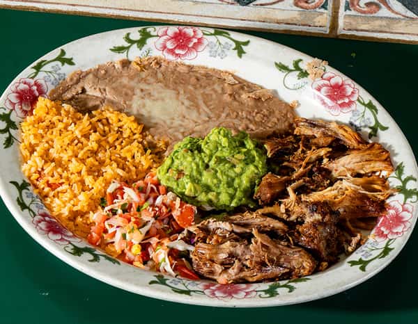 Carnitas plate with rice, refried beans, guacamole, and pico de gallo