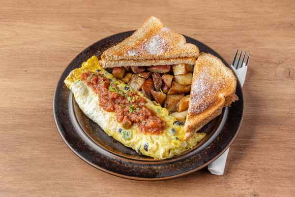 Vegetable omelet topped with salsa served with home fries and toast, classic American diner breakfast plate