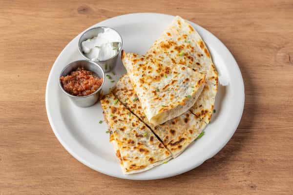 Cheese quesadilla with crispy tortilla served with salsa and sour cream, casual diner-style appetizer