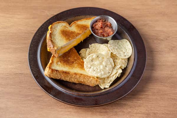 Grilled cheese sandwich on toasted bread with kettle chips and house salsa, classic American comfort food