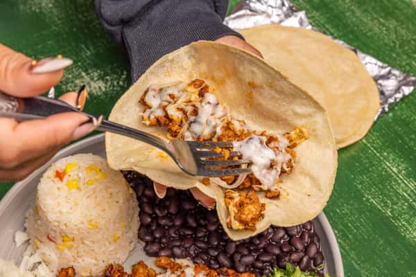 Person filling taco with meat