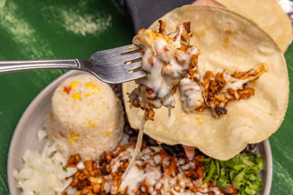 A fork full of creamy Mexican food