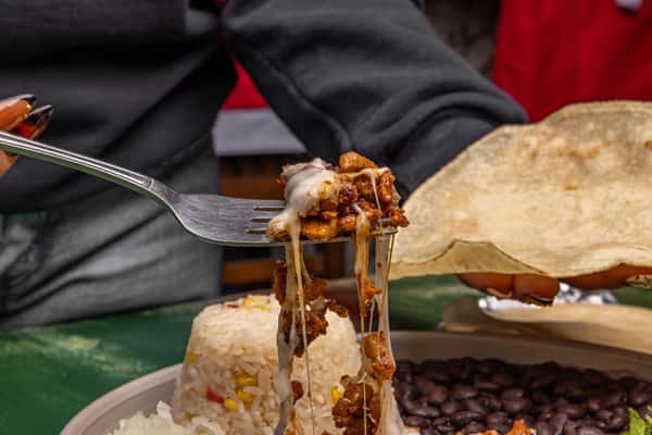A fork full of creamy Mexican food