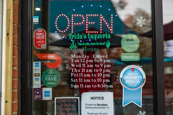 Exterior shot of restaurant window with stickers and signage