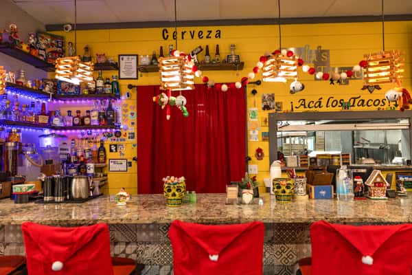 Interior of restaurant with decorated wall paintings, photos, and ornaments