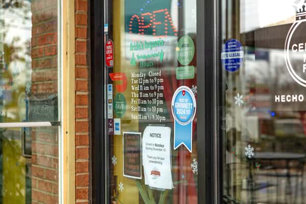 Exterior shot of restaurant window with stickers and signage