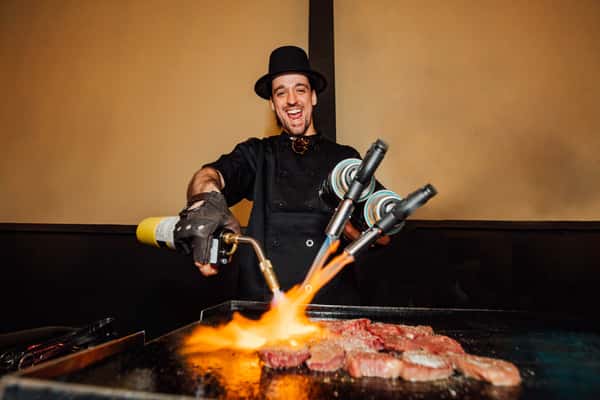 Person torching food for a steampunk culinary experience