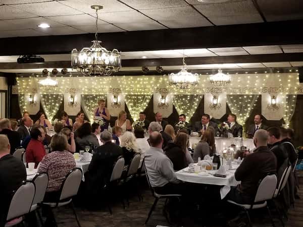 room filled with people sitting at tables and chairs for a party